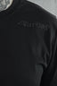 Close up of the black Dirtbag Core Tee featuring a subtle black on black raised Dirtbag logo across the chest. The image highlights premium minimalist streetwear design, textured logo detailing, soft fitted cotton fabric and the bold attitude driven Dirtbag lifestyle aesthetic.